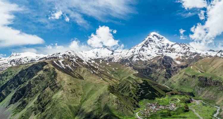 Mountain village nestled in a green valley.