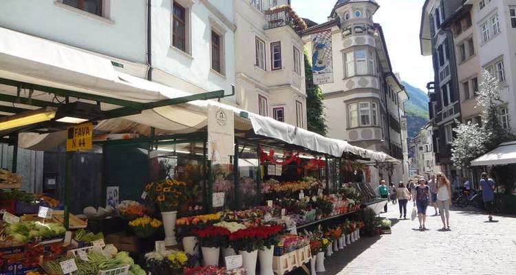 Bustling street market with flowers and local vendors.