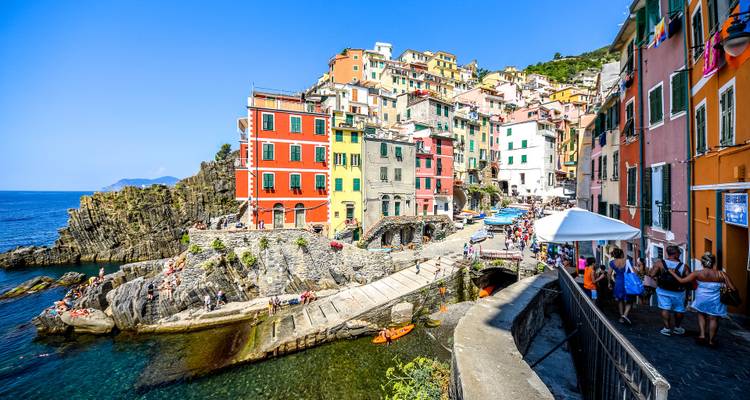 Brightly-colored buildings line a harbor in a coastal town.