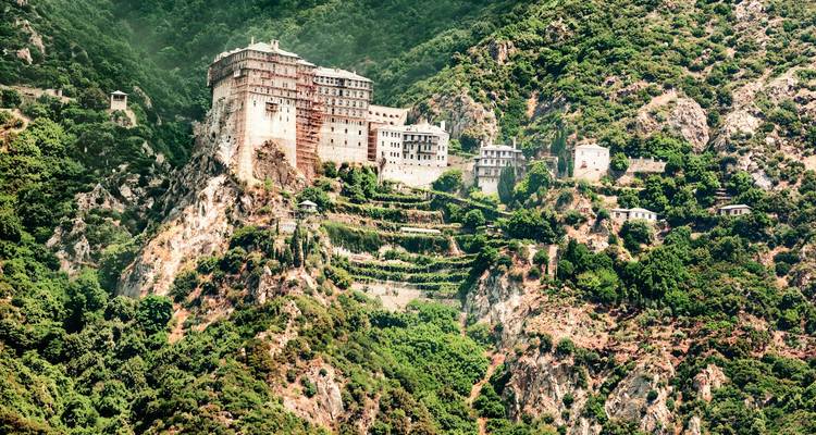 Le complexe monastique en pierre ancienne s'accroche aux falaises escarpées et boisées du Mont Athos, bien au-dessus de la mer Égée.