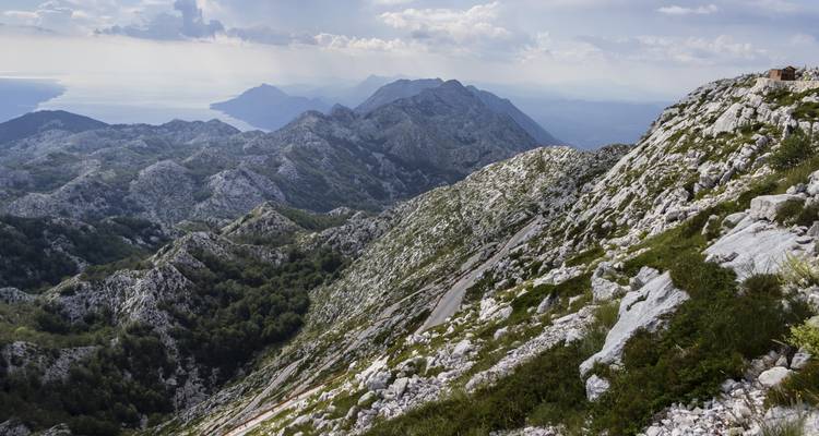 Vue sur les montagnes rocheuses avec une mer lointaine.