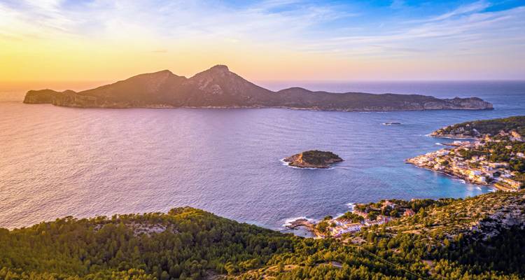 Coastal aerial view at sunset with small islands.