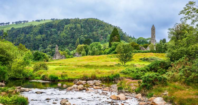 Ancient ruins and round tower in Glendalough Valley.