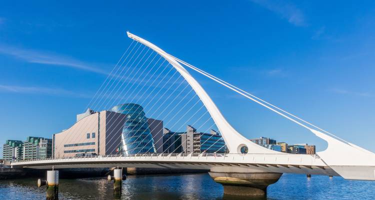 Samuel Beckett Bridge with modern architecture in the background.