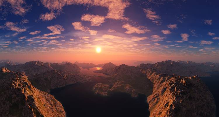 Sunset over a dramatic mountainous landscape.
