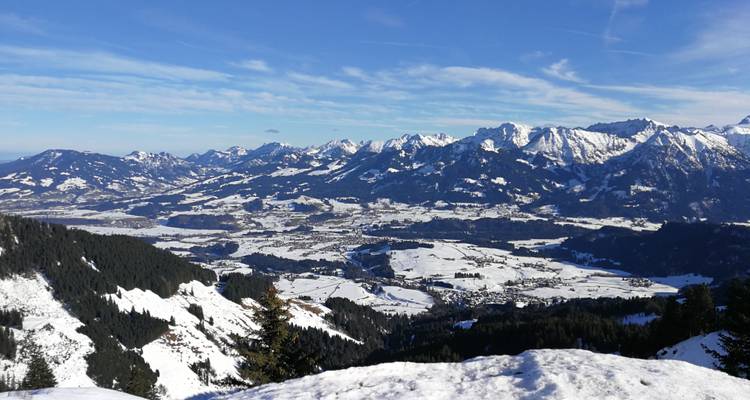 A panoramic view of snowy landscapes and distant mountain ranges.