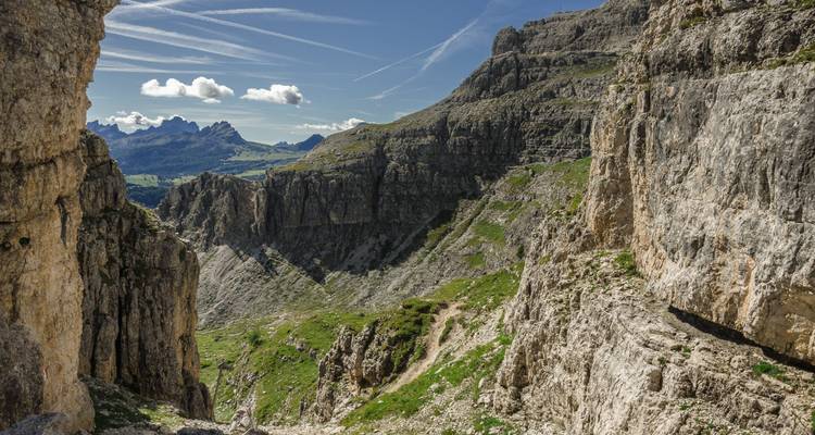 Steep rocky cliffs with a path winding through mountainous terrain.