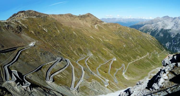 Winding mountain road through a barren landscape.