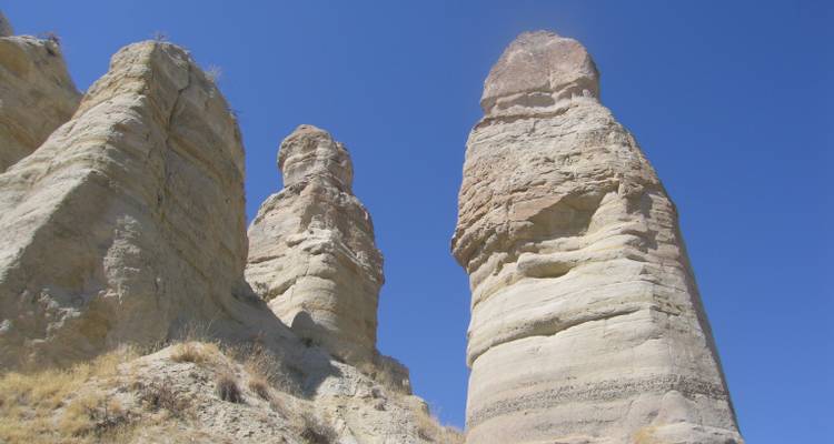 Close-up view of Cappadocia's towering rock formations against a clear sky.