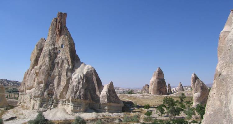 Tall rock formations reaching towards a clear sky.