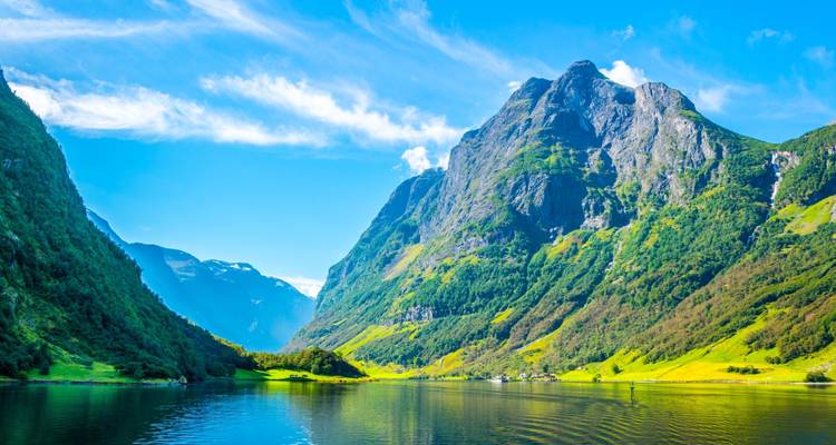 Majestic mountain and fjord scenery under a clear blue sky.