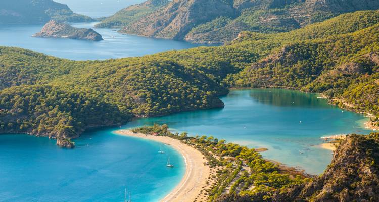 Scenic view of blue lagoons and green hills.