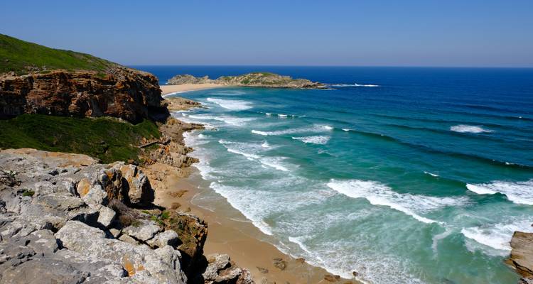 Rocky cliff viewpoint overlooking crashing waves along a rugged coastline