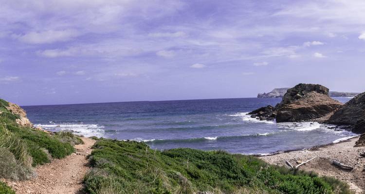 Path leading down to a rocky ocean shore.