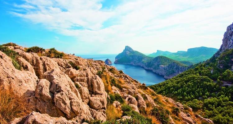 A scenic view of cliffs, sea, and clear blue sky.