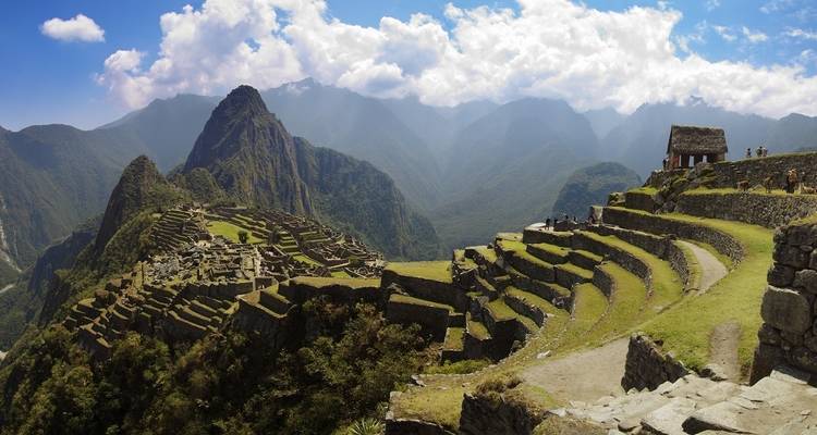 Panoramisch uitzicht op de ruïnes van Machu Picchu met bergachtige achtergrond.