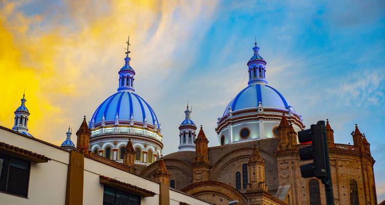 Blue-domed cathedral against a vibrant sky.