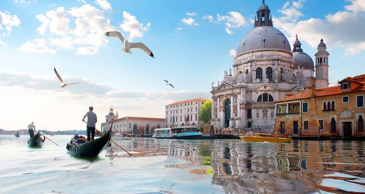 Venetian canal with gondolas and historic buildings.