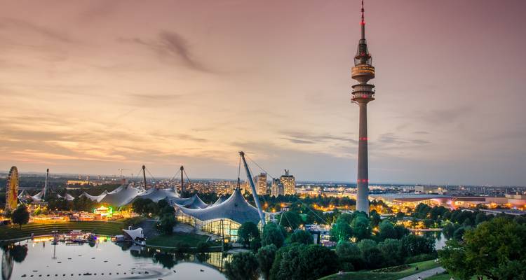 Munich Olympic Park with TV tower at sunset.