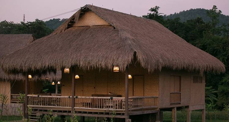Traditioneel gebouw met rieten dak in de schemering.