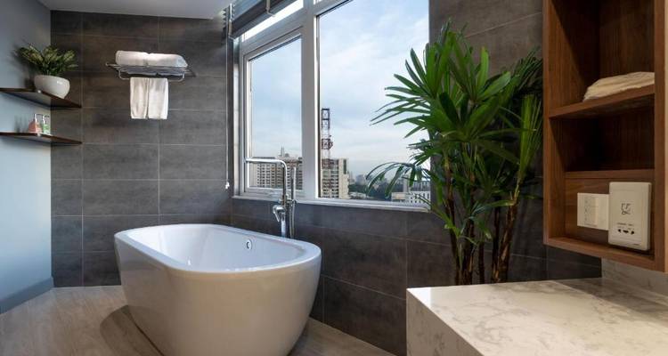 Modernes Badezimmer mit einer freistehenden Badewanne und großen Fenstern.