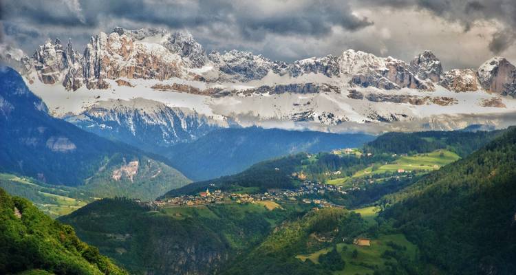 View of Dolomites from Merano with snowy peaks.