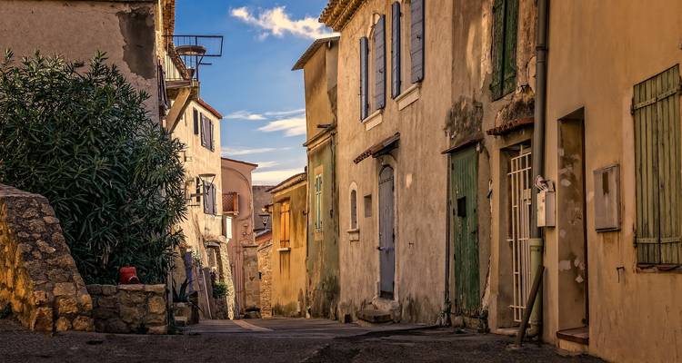 A small, rustic alley with old buildings.