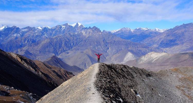Hiker on a mountain ridge with breathtaking views.