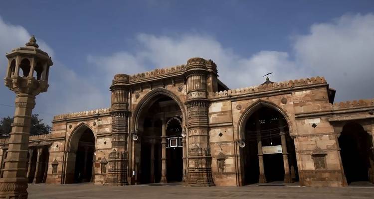 Front façade of Jama Masjid Ahmedabad with arched gateways under a blue sky