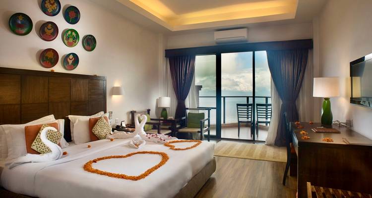 Elegant hotel room with heart-shaped decoration.