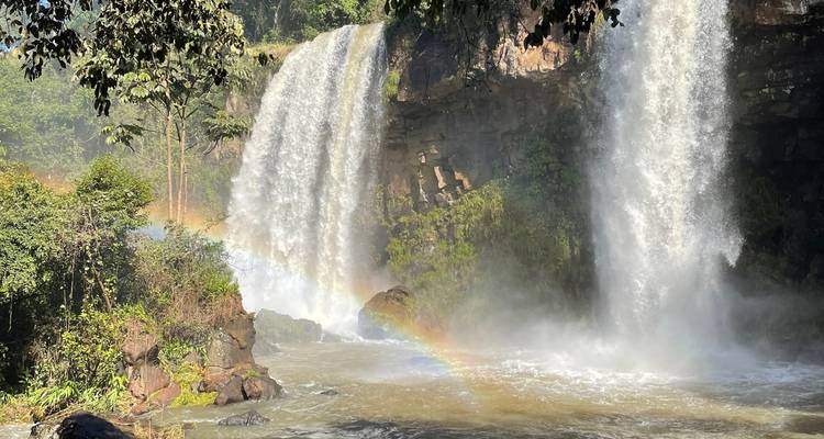 Grande cascade avec brume et un arc-en-ciel partiel.