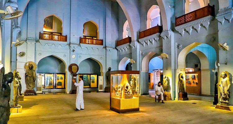 Interior of a museum with ancient sculptures and artifacts.