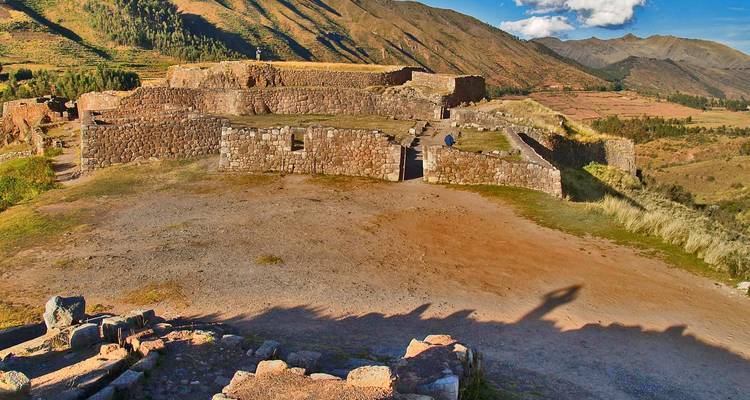 Ancient ruins on a hilltop with stone walls.