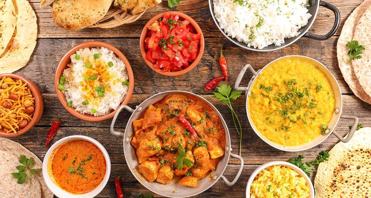 Assortiment d'aliments et de plats traditionnels servis sur une table rustique.