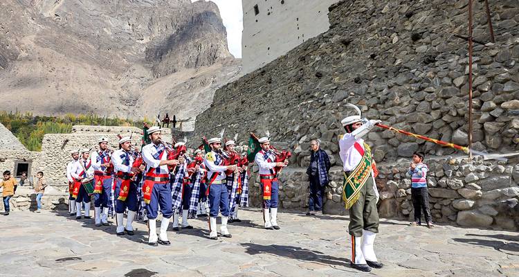 Actuación cultural con músicos en vestimenta tradicional en una fortaleza.