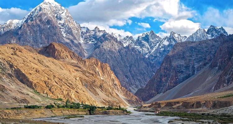 Magnificent mountain range with a narrow valley and small settlement.