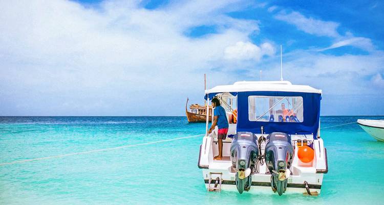 Tourist boat anchored on a serene turquoise sea.