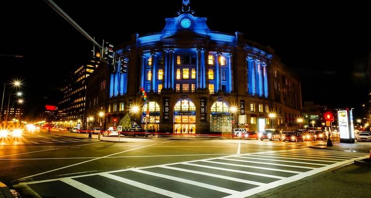 Building illuminated with blue lights at night in the city.