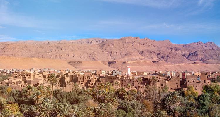 Traditional village with scenic mountain backdrop.