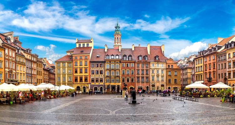 Colorful historic buildings and a plaza in Warsaw.