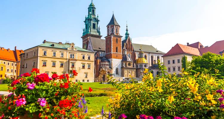 Wawel Castle in Krakow surrounded by vibrant flowers.
