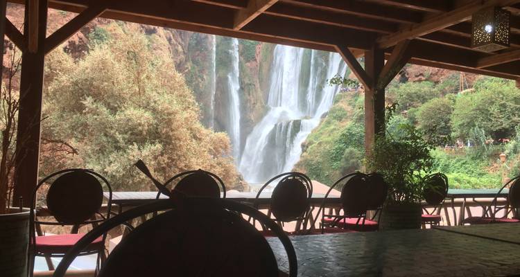 View of large waterfalls seen from a wooden veranda.