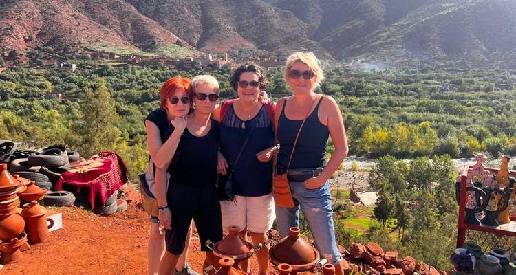 Group of women posing in front of a scenic mountain landscape.
