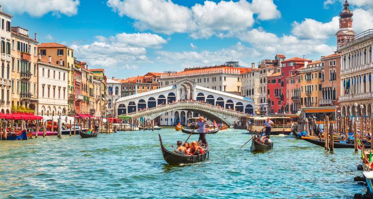 Iconic Grand Canal in Venice with gondolas and historic buildings.