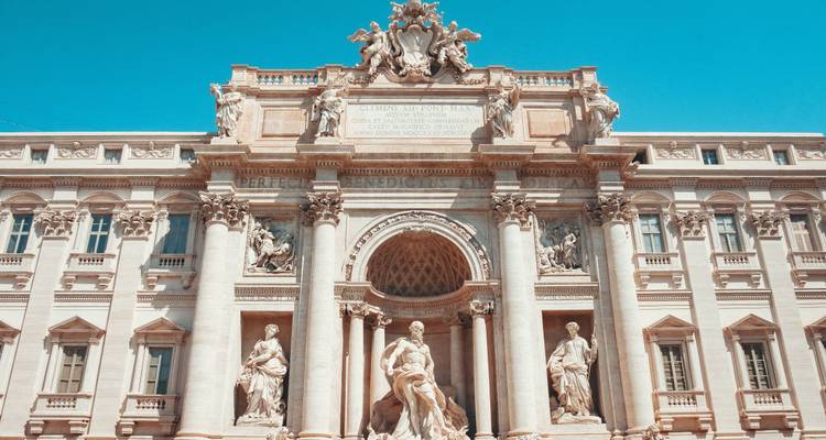 Detail of a historic building facade with sculptures in Rome.