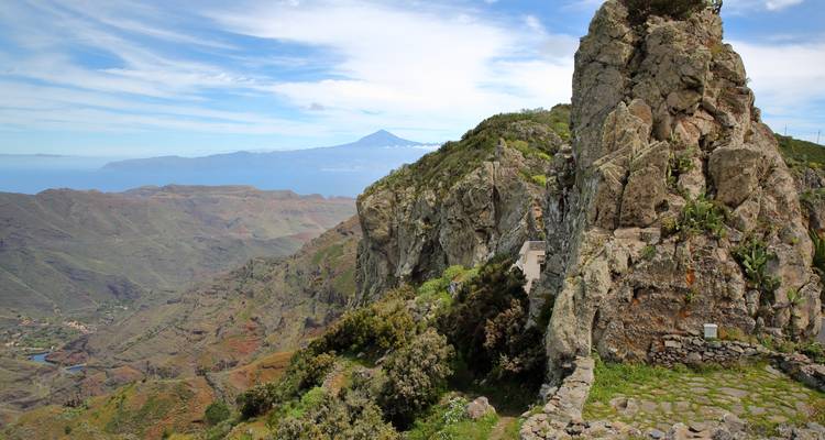 Mountainous landscape with a dramatic cliff overlooking the ocean.