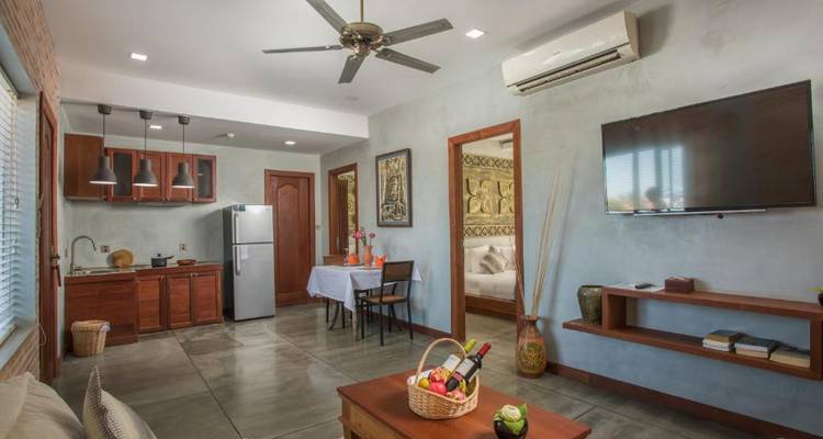 Living area with modern kitchen and dining table.