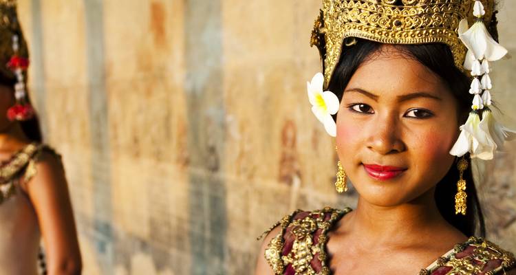 Portrait of a woman in traditional attire with floral accessories.