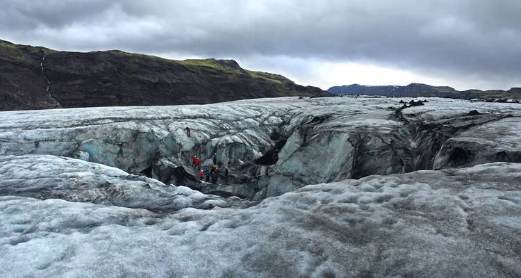 Hikers walking on Solheimajokull glacier in Iceland.
