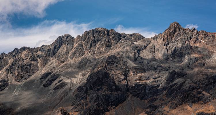 Rugged mountain peaks under a blue sky.